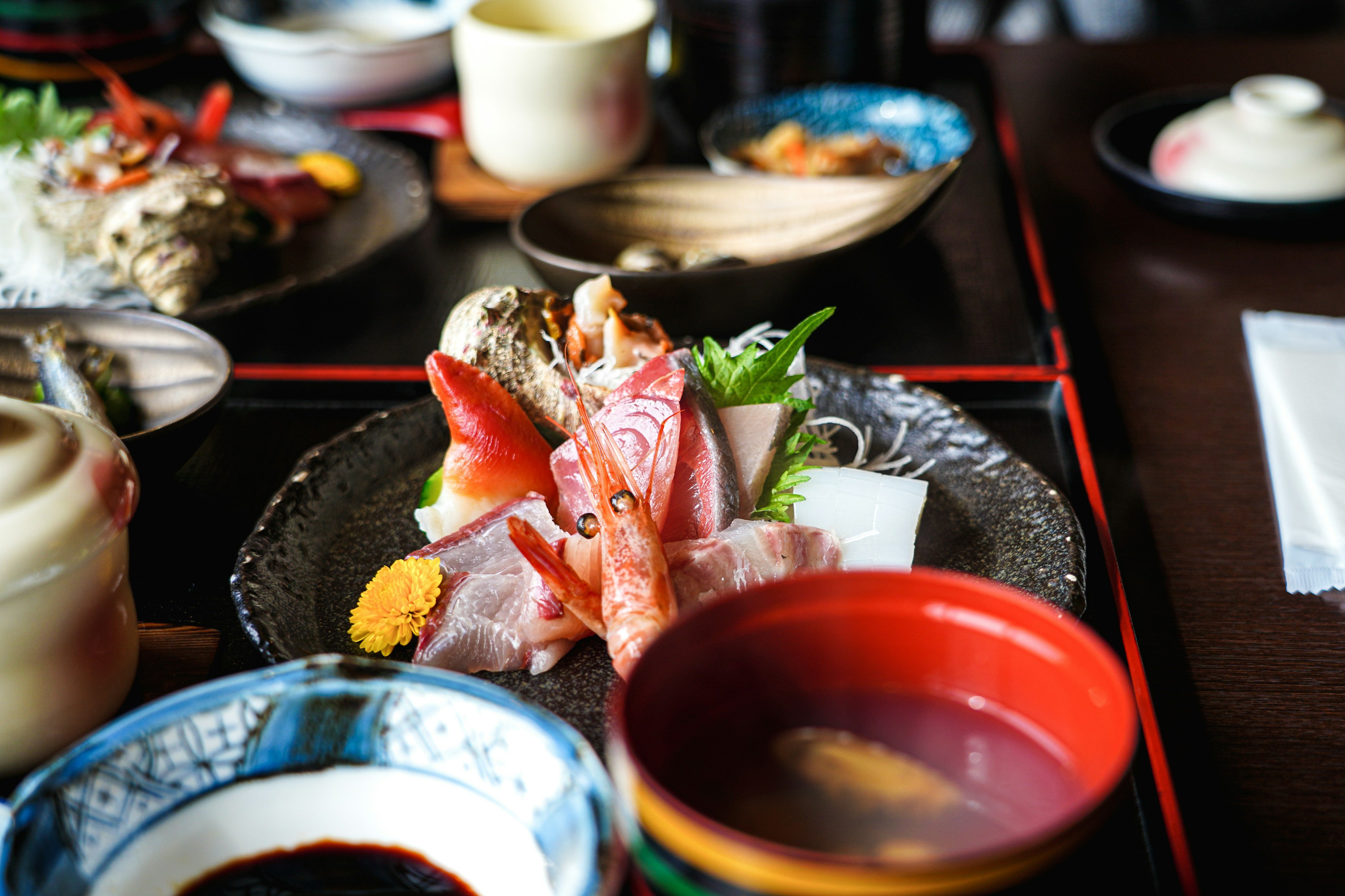 Traditional kaiseki sashimi platter with seasonal garnishes