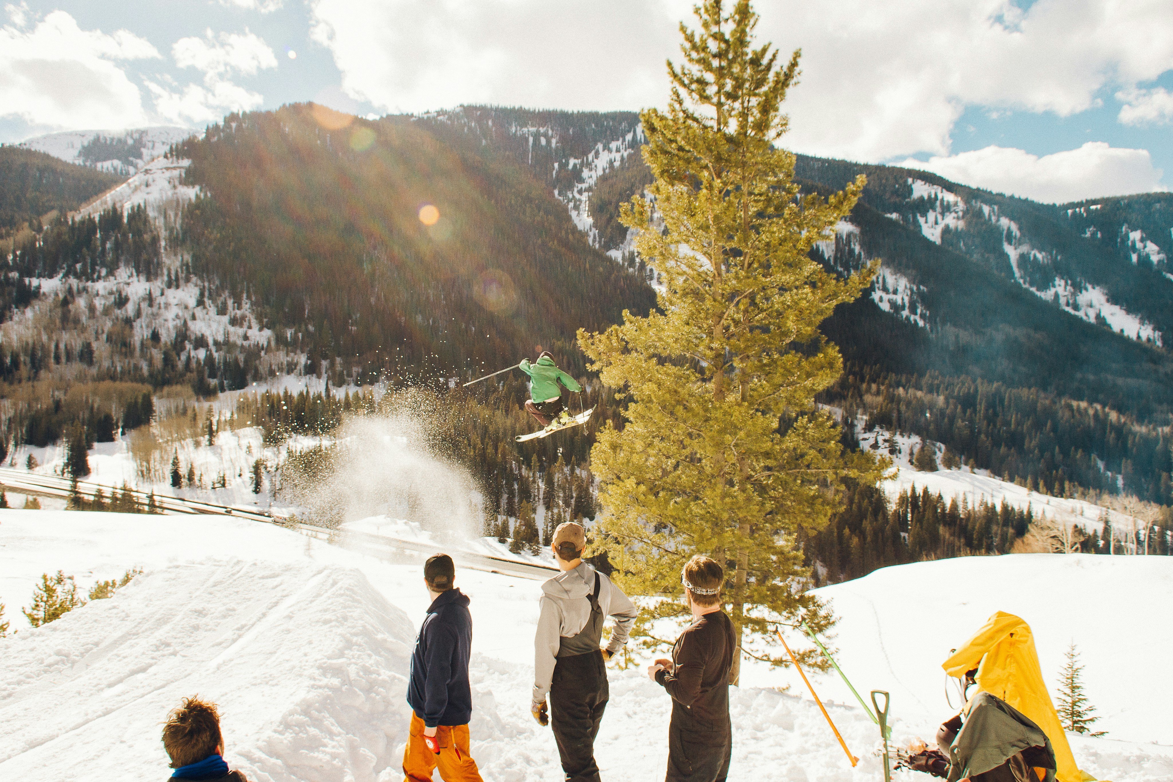 Group of people on a snowy mountain with pine trees